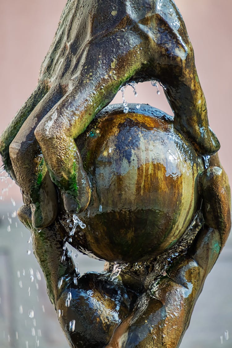 A Pair Of Brown Concrete Hand Statue Holding A Ball