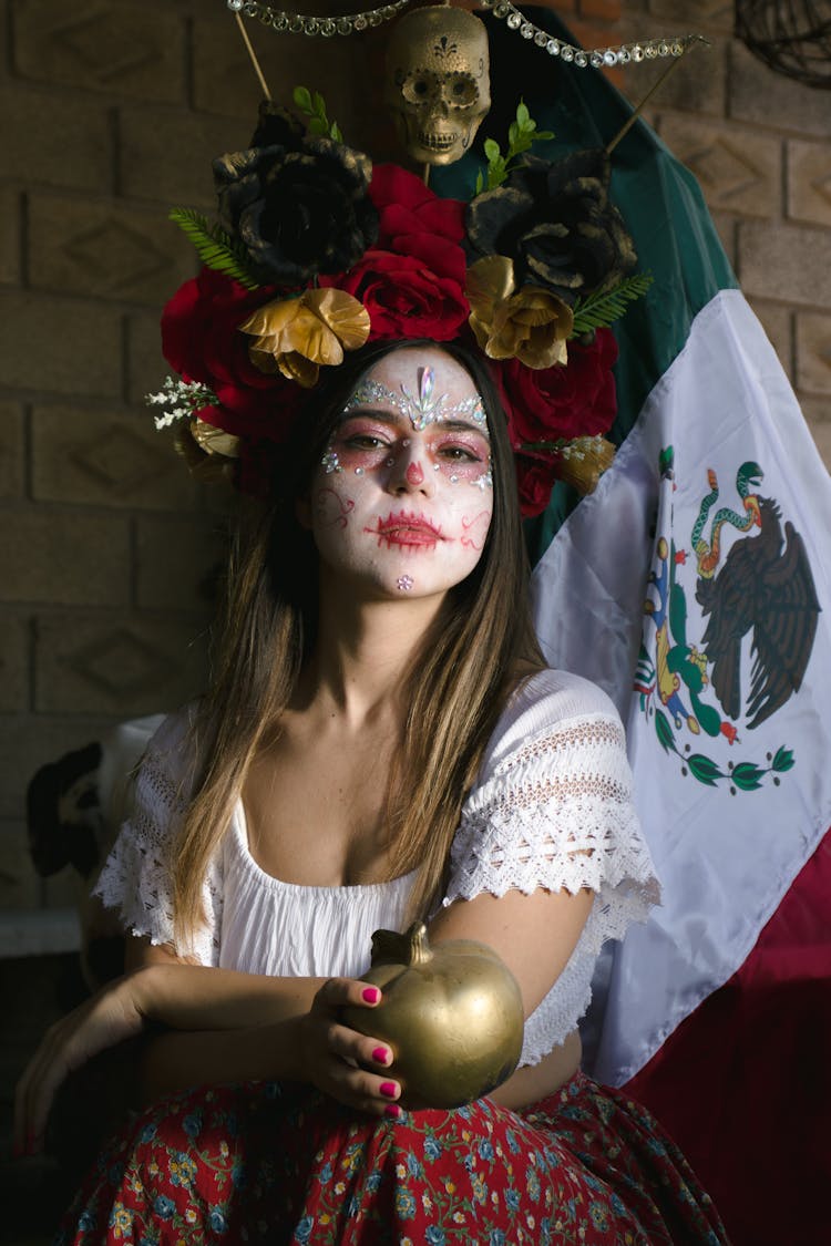 Woman In White Face Paint Holding Golden Apple