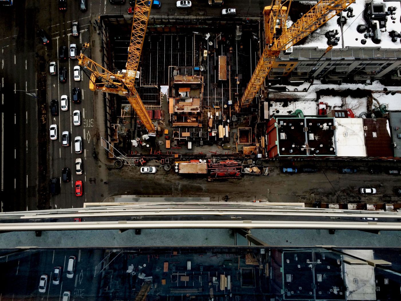 Aerial view of an urban construction site with cranes