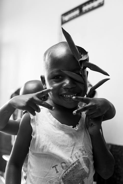 Grayscale Photo of a Smiling Girl Wearing a Tank Top