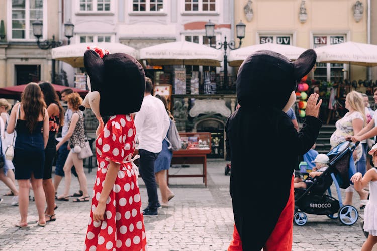 Two People Wearing Mickey And Minnie Mouse Costumes