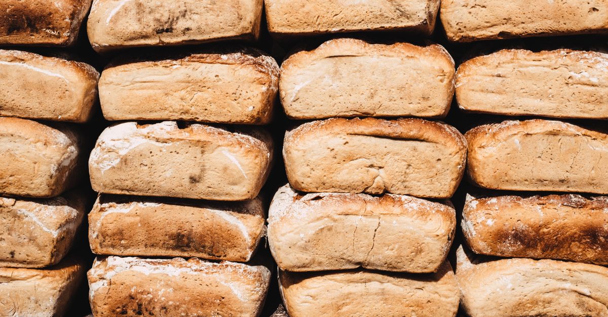 Women working in Christ Embassy Ho community bakery, stacking bread loaves
