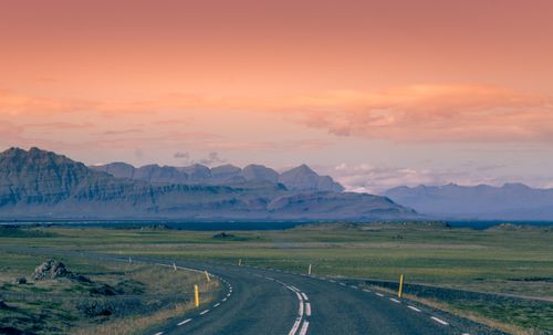 Free A captivating view of an open road leading through Iceland's scenic highlands, captured at sunset. Stock Photo