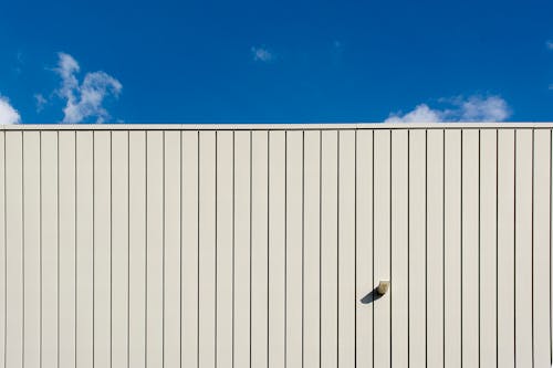 White Metal Wall and Blue Sky