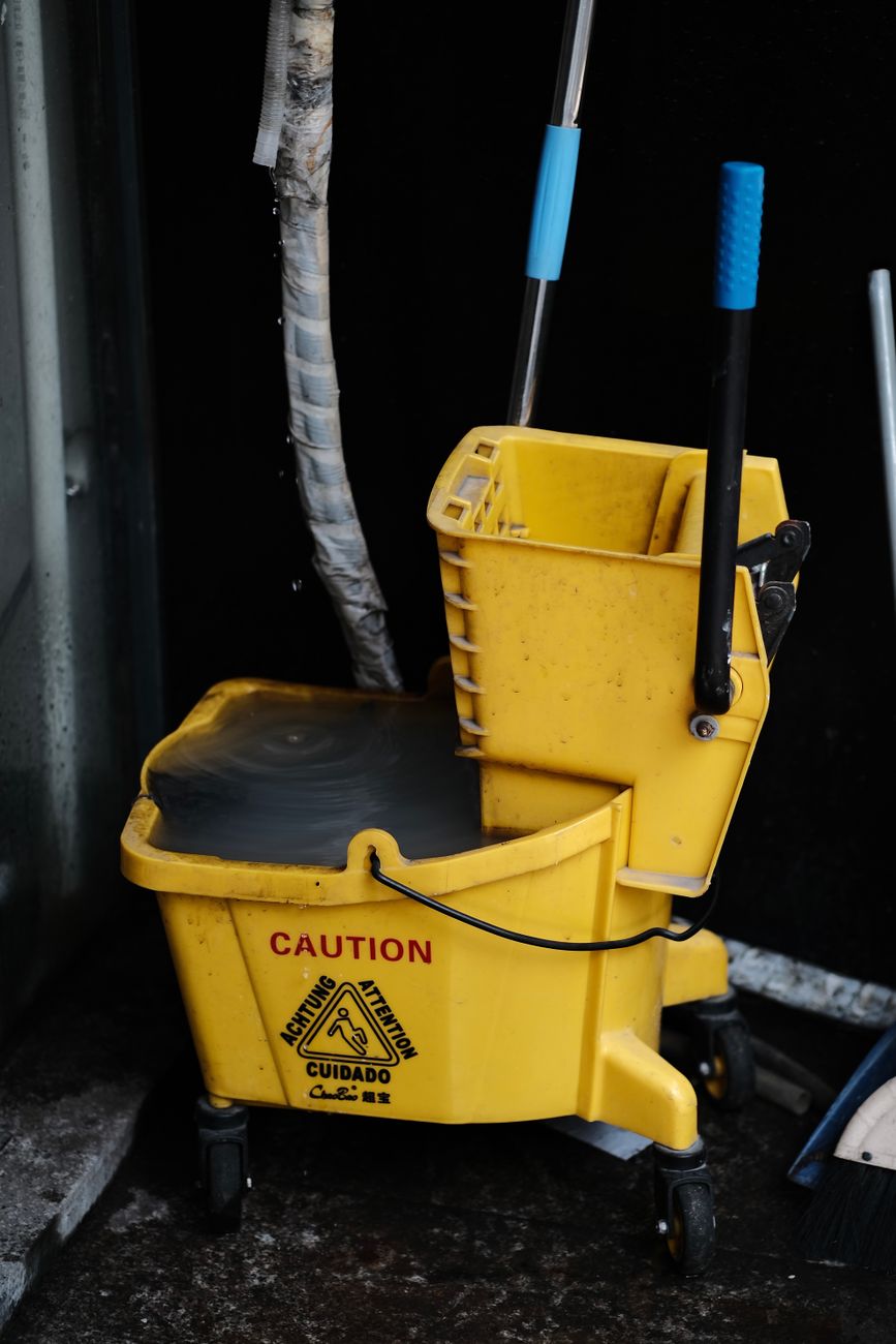 commercial cleaning scope of work with mop bucket and caution sign