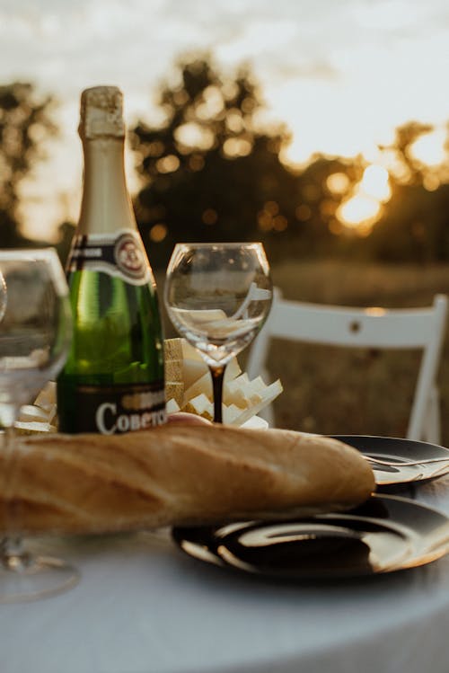 A Bottle of Champagne and Glass on the Table