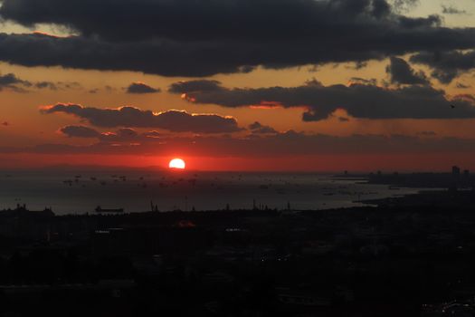 Beautiful sunset view with silhouettes and calm sea atmosphere.