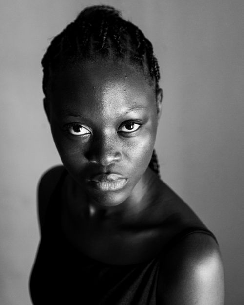 Free Elegant black and white portrait of a woman with braided hair looking confidently at the camera. Stock Photo