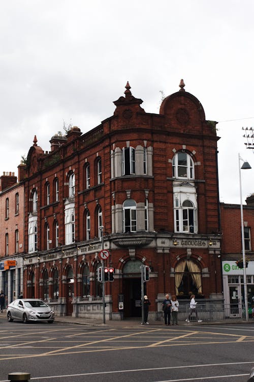 People Standing Outside Bohemian Pub Building