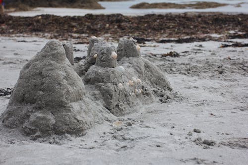 A Gray Sand Formation with Rocks in a Beach