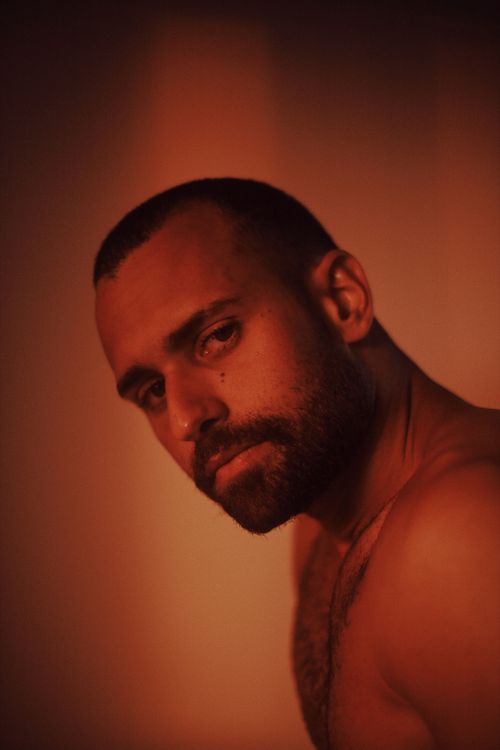Free Intense and evocative portrait of a man with beard in warm lighting. Stock Photo