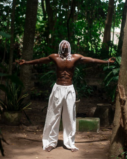 Muscular Shirtless Man Posing in Forest