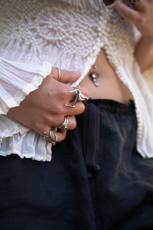 Woman with Rings on Hand and Navel Piercing