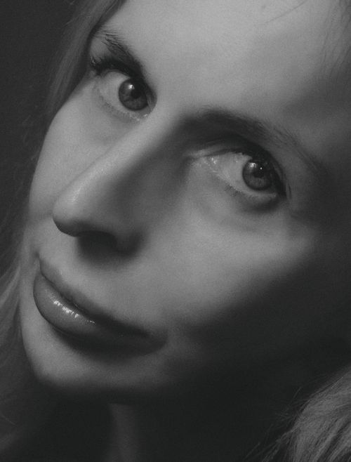 Free Close-up black and white portrait of a woman with captivating eyes and soft expression. Stock Photo