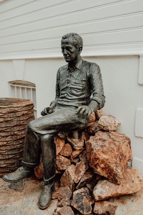 Free Bronze statue of a seated man on rocks, located in Turkey, showcasing historical artistry. Stock Photo