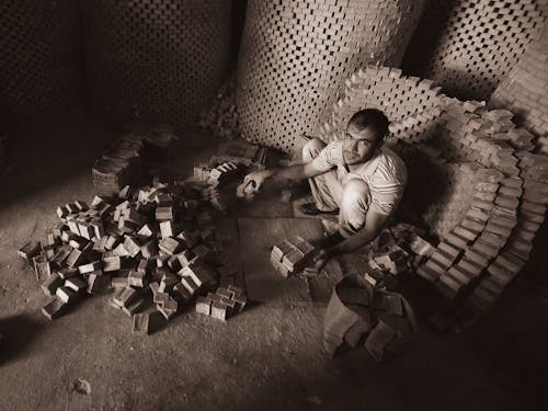 Worker Stacking Bricks