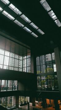 Interior architecture of a modern office building in South Jakarta, featuring large windows and skyscrapers outside.