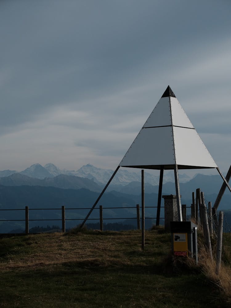 A White Triangle Shaped Tent On A Mountain