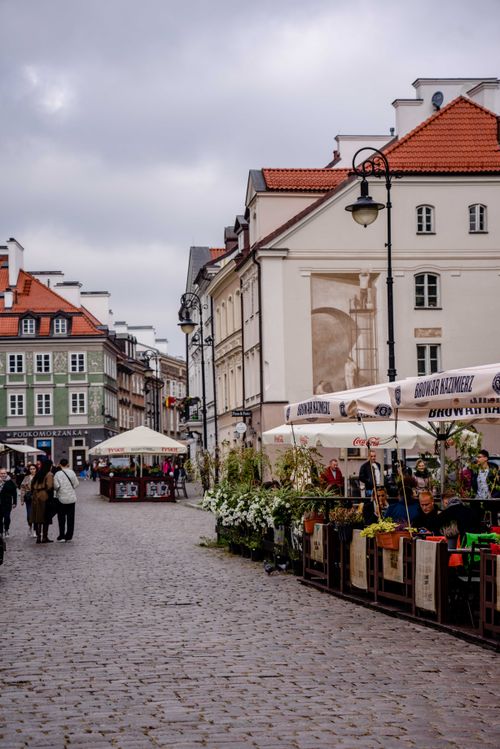 Free Explore the vibrant marketplace of Warsaw's historic Old Town, with bustling street vendors and classic architecture. Stock Photo