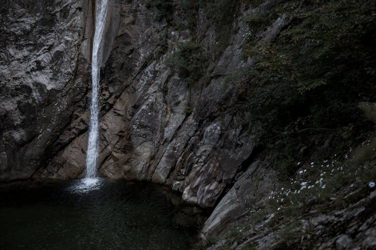 Photo Of Waterfalls On Rocky Cliff