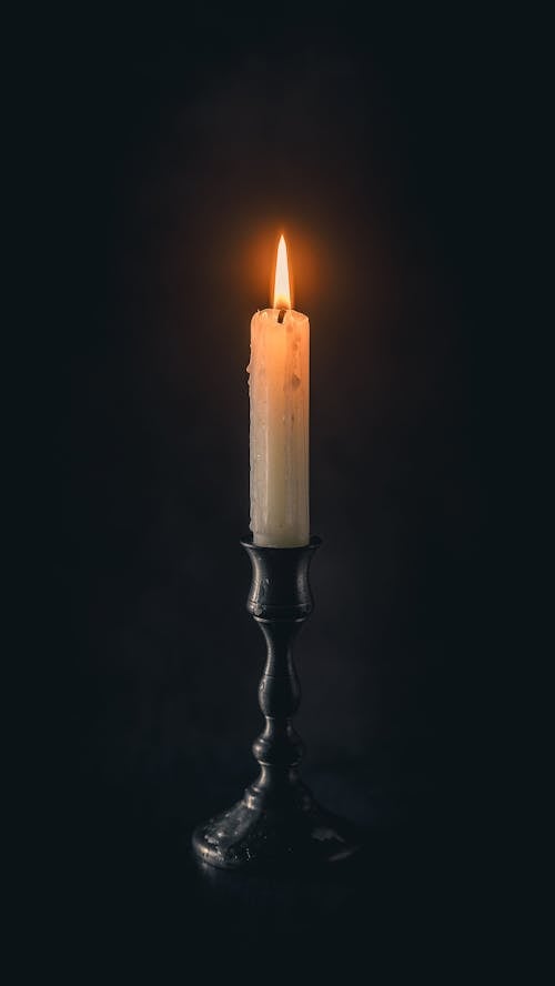 Lighted Candle on Black Candle Holder