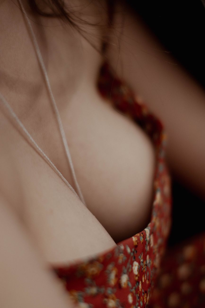 Intimate close-up of a red floral top highlighting feminine elegance and style.