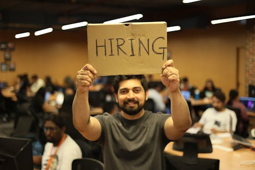 Man Holding a Poster in an Office 