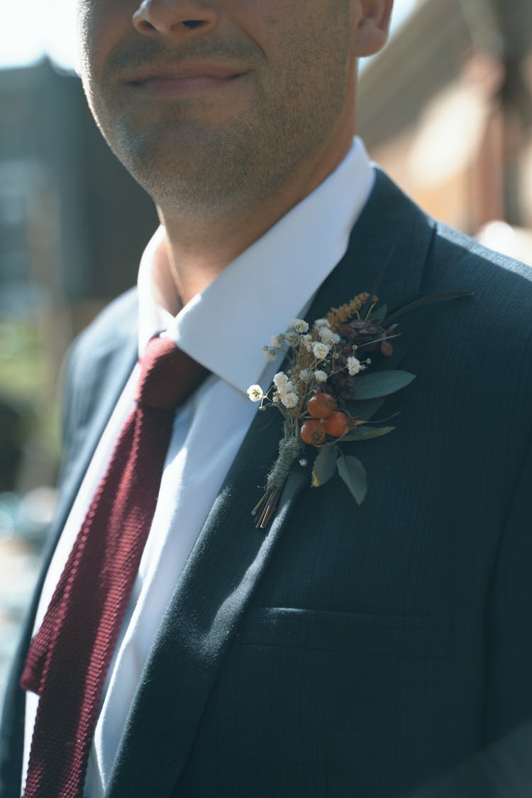 A Man Wearing A Suit With Boutonniere