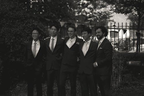 Grayscale Photo of Five Men Wearing Black Suits