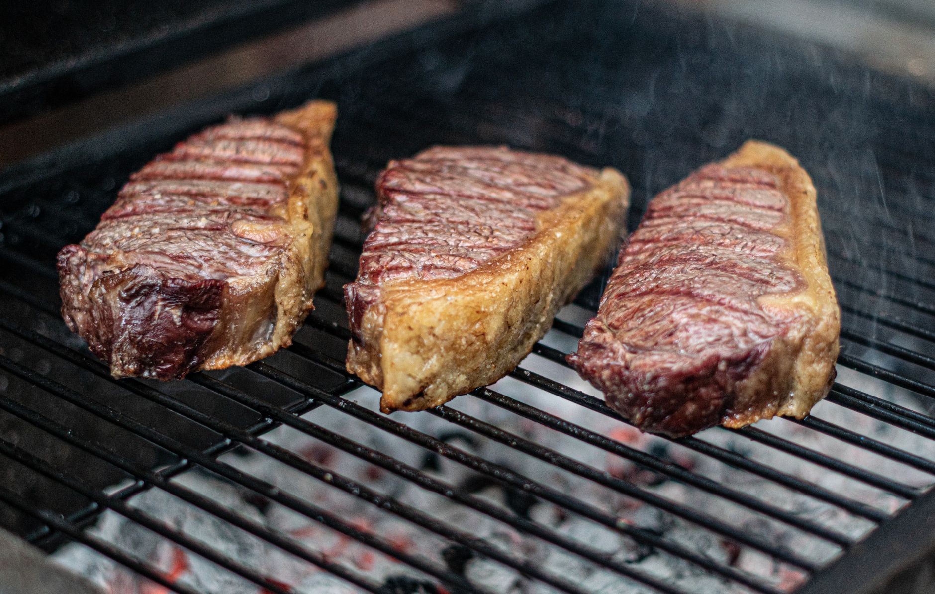 Perfectly grilled coulotte steak resting on a wooden board