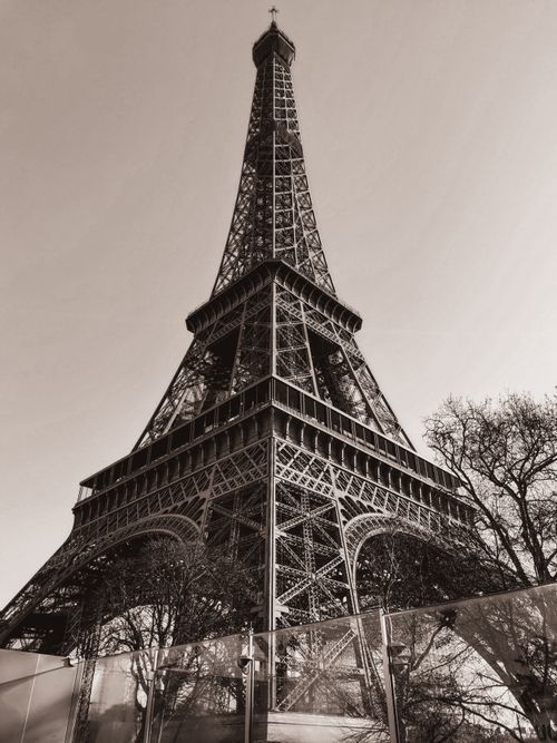 Free Artistic sepia photo of the Eiffel Tower in Paris, captured from a low angle. Stock Photo