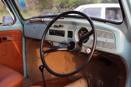 Explore the classic interior of a vintage car featuring a retro dashboard and elegant steering wheel.