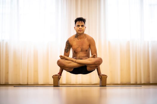 Adult man performing advanced yoga pose with focus on balance and strength.