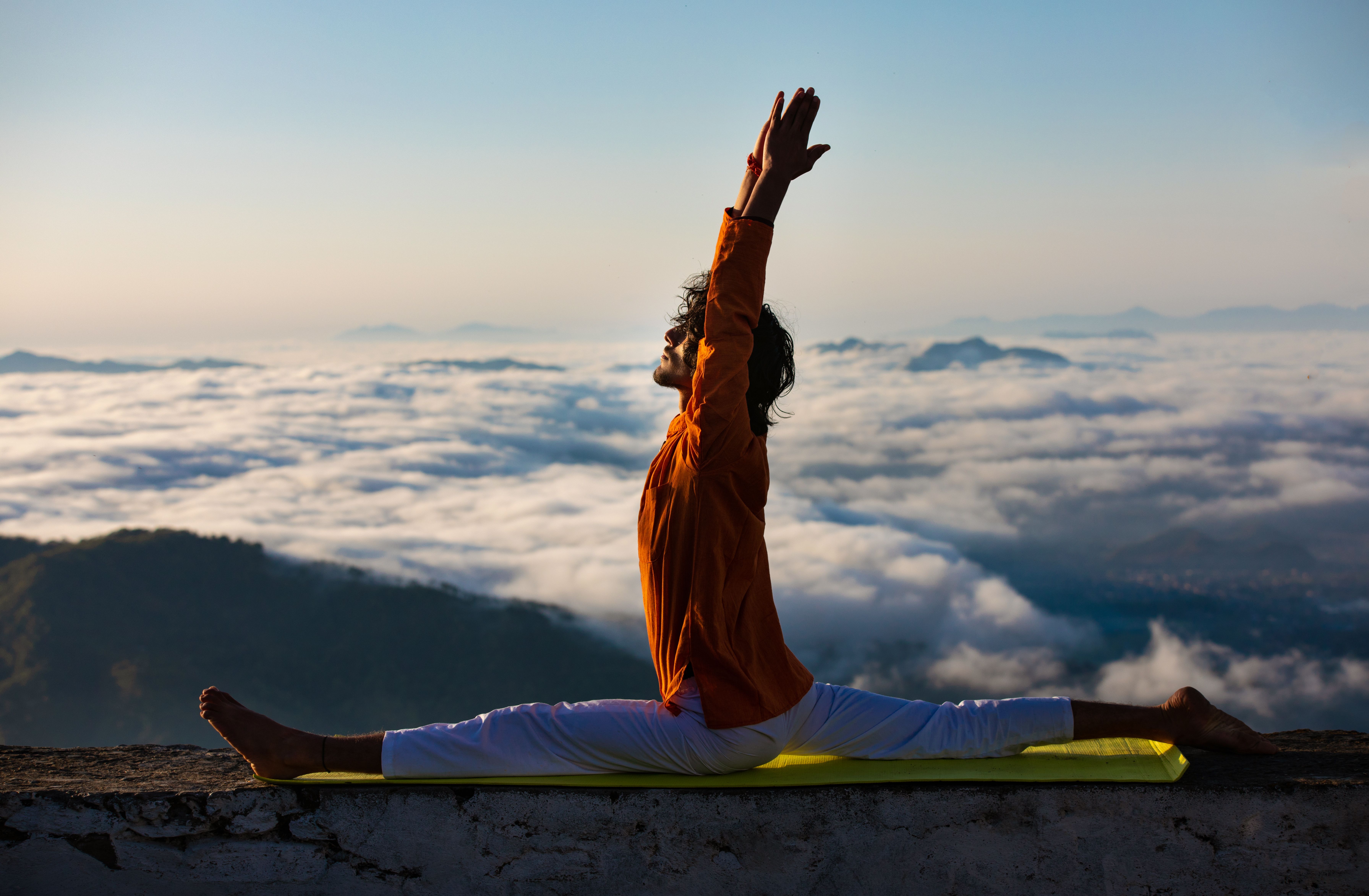 A Man Meditating on a Concrete Ledge · Free Stock Photo