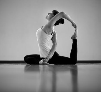 Adult woman demonstrating flexibility in a yoga pose indoors.