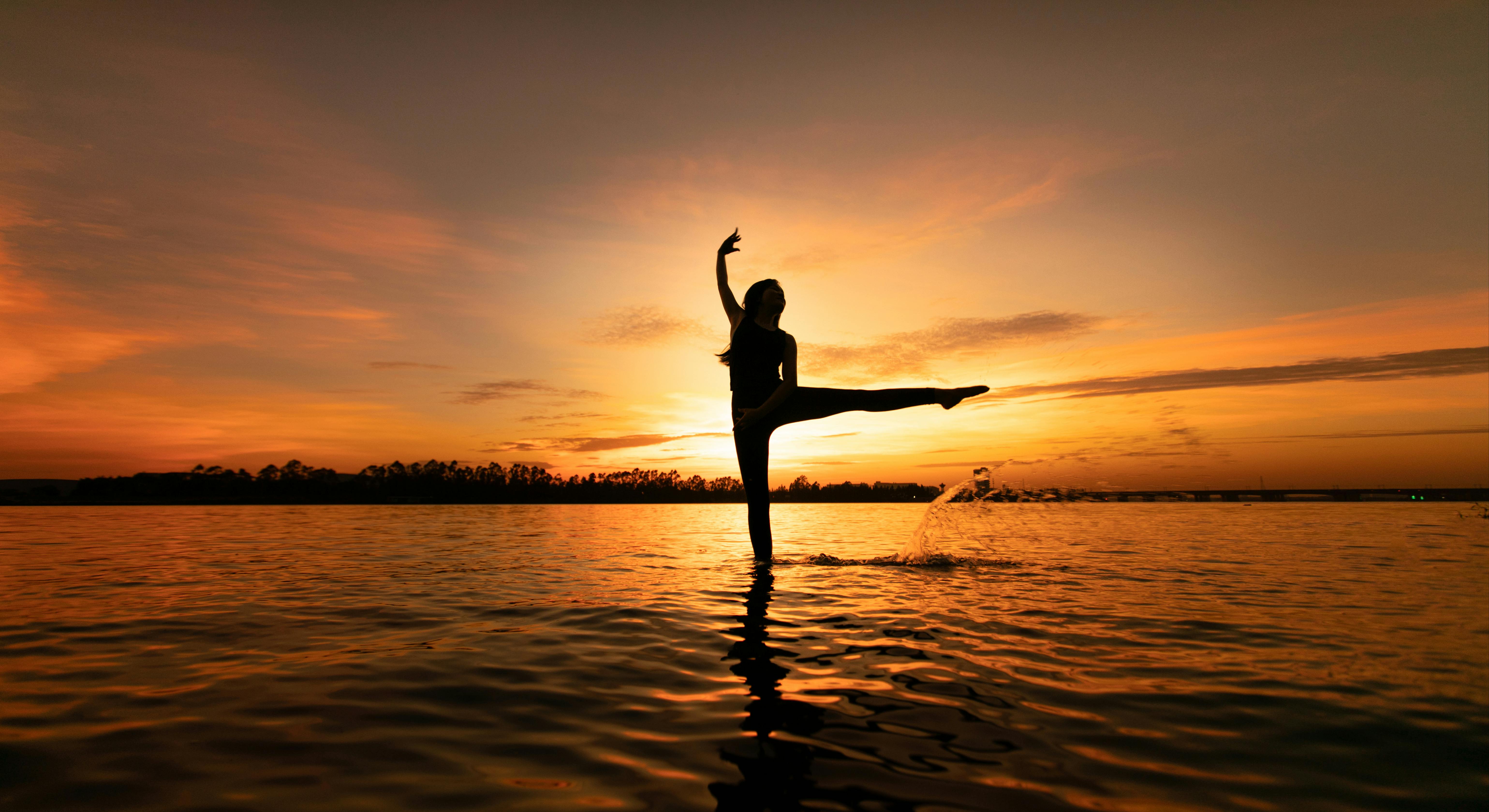 Silhouette of a girl doing yoga against the background of panoramic Windows  in a modern yoga Studio Stock Photo by sviatlankayanka