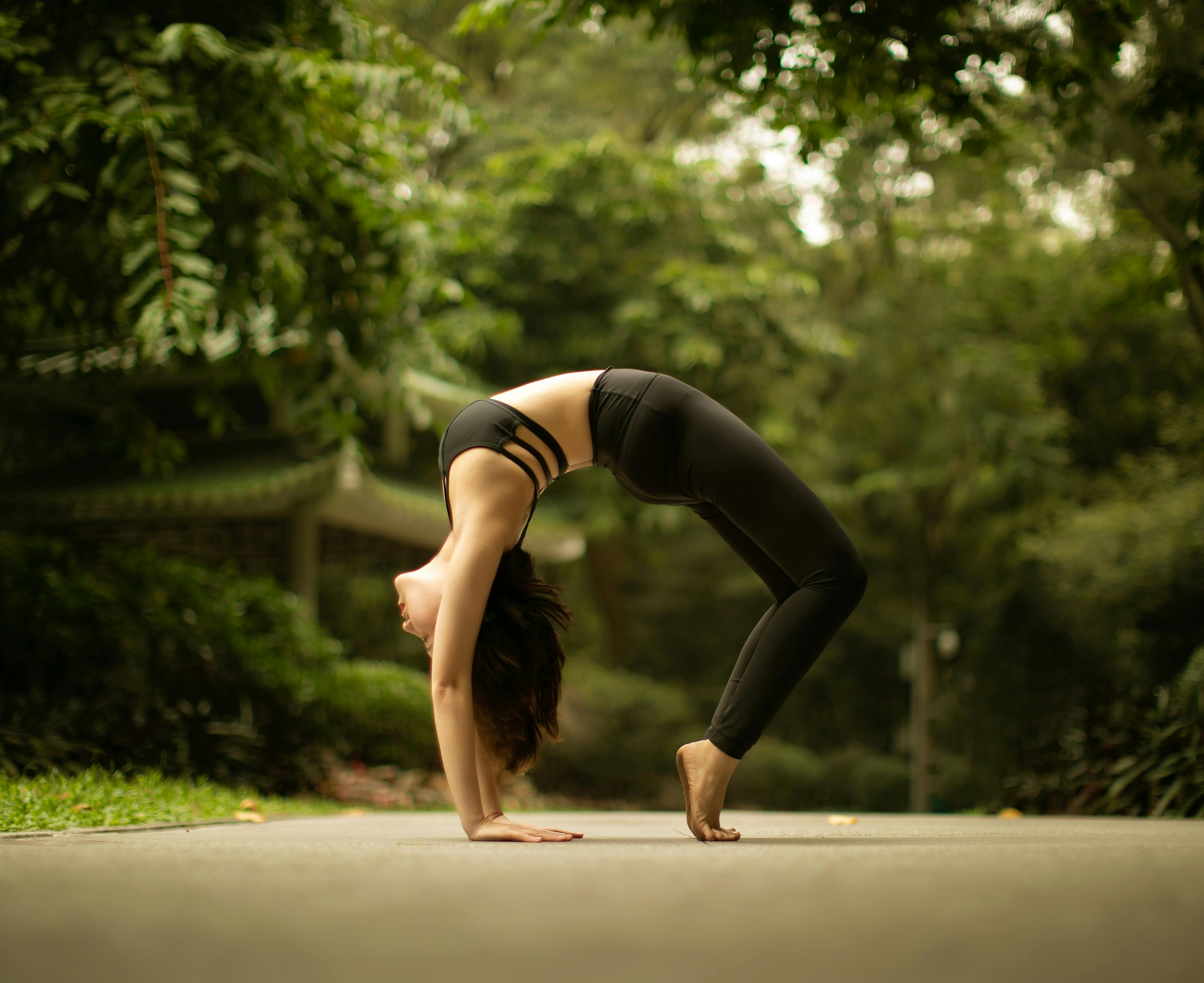 Flexible Woman Doing Yoga Poses Parivritta Kraunchasana Gray Background  Young Stock Photo by ©Xelastia 382014042