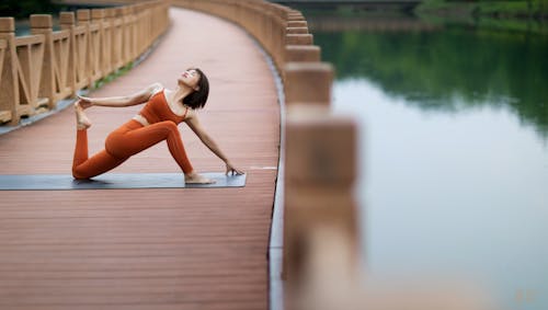 Woman Doing Yoga on a Bridge
