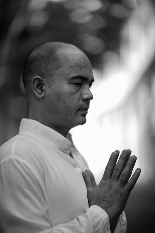 Black and White Photo of a Man Praying with his Eyes Closed