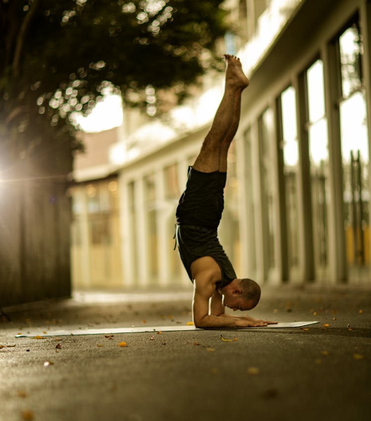 Man In Yoga Figure With Legs Raised