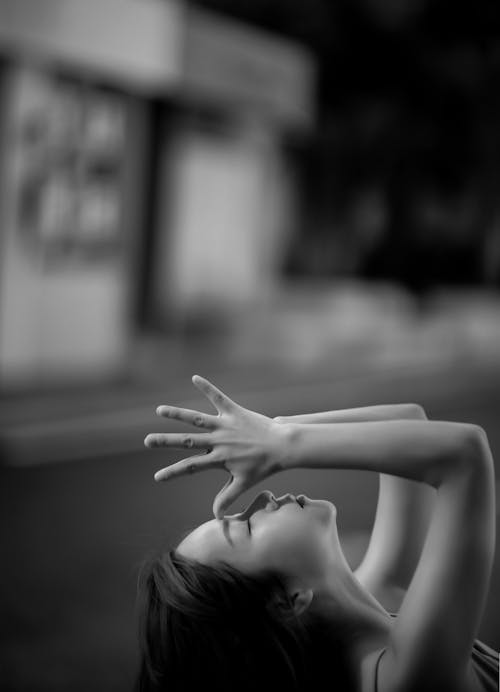 Grayscale Photo of a Woman With Hands Together