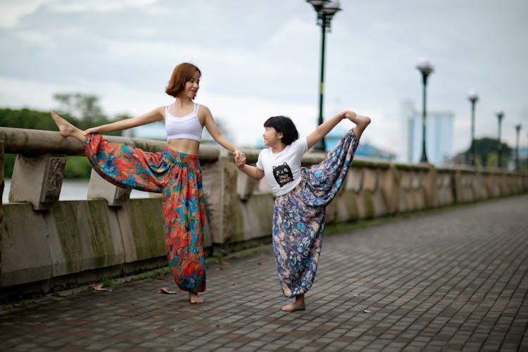 Woman And Child Stretching On Street