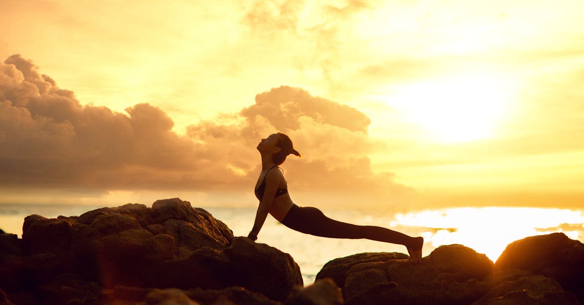 A Woman Doing Stretching on the Rocks · Free Stock Photo