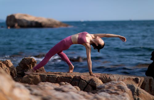 A Woman Doing Workout Near the Sea 
