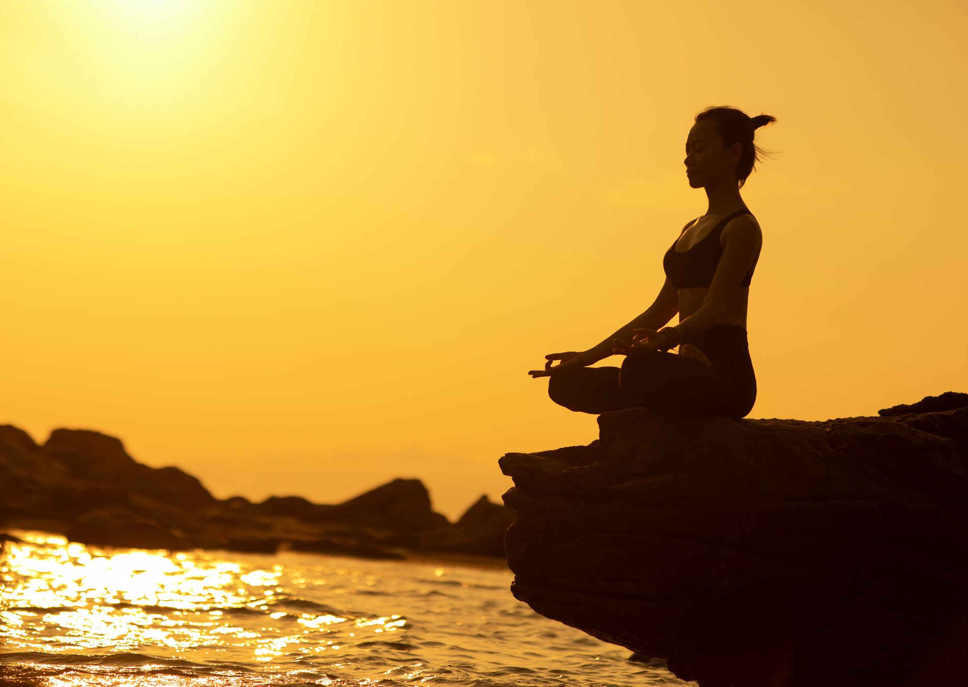 A seated practice at sunset, looking out to sea