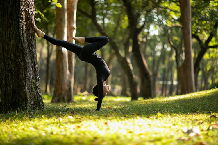 Woman In Yoga Figure In Park