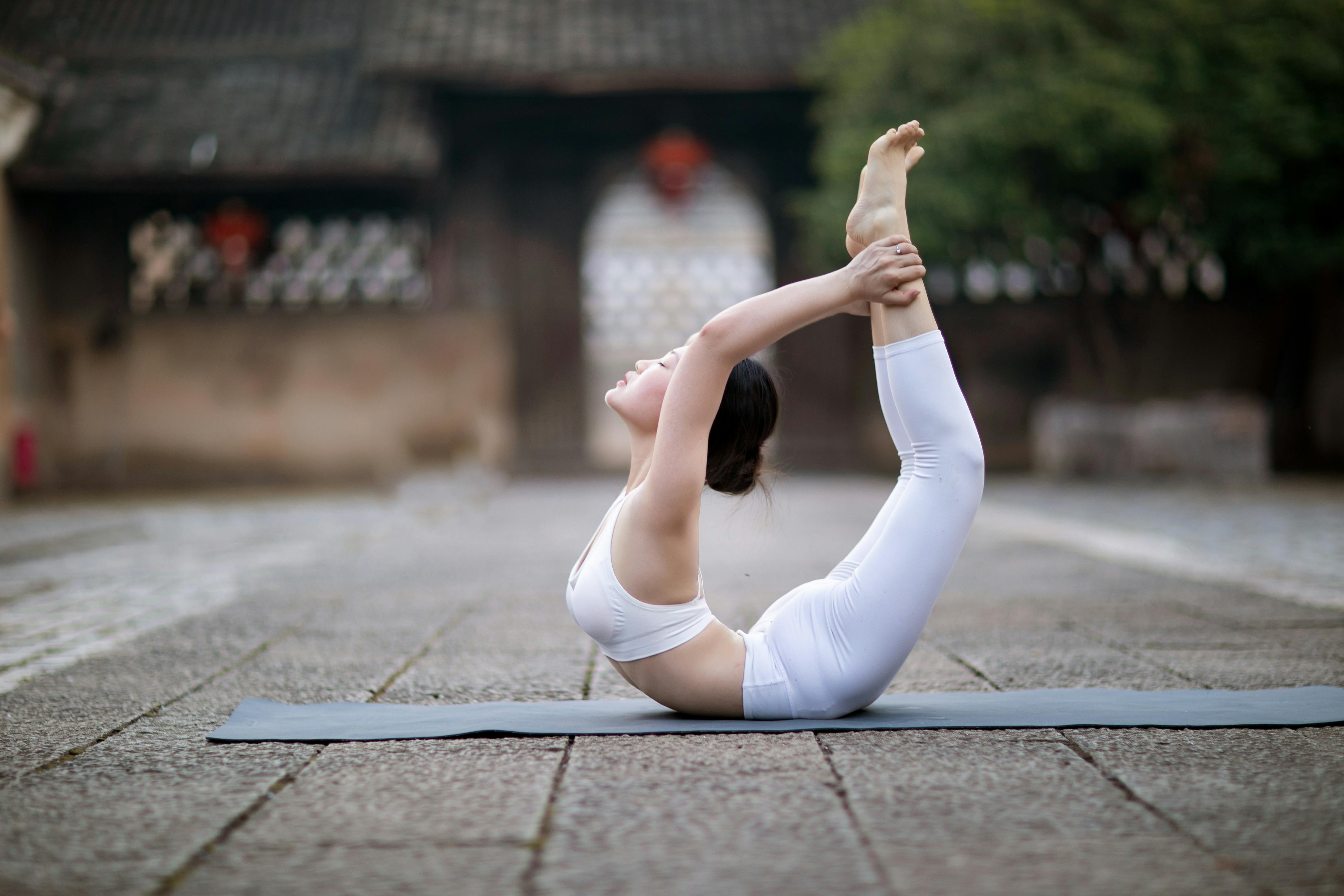 Woman in Gray Leggings and Black Sports Bra Doing Yoga on Yoga Mat