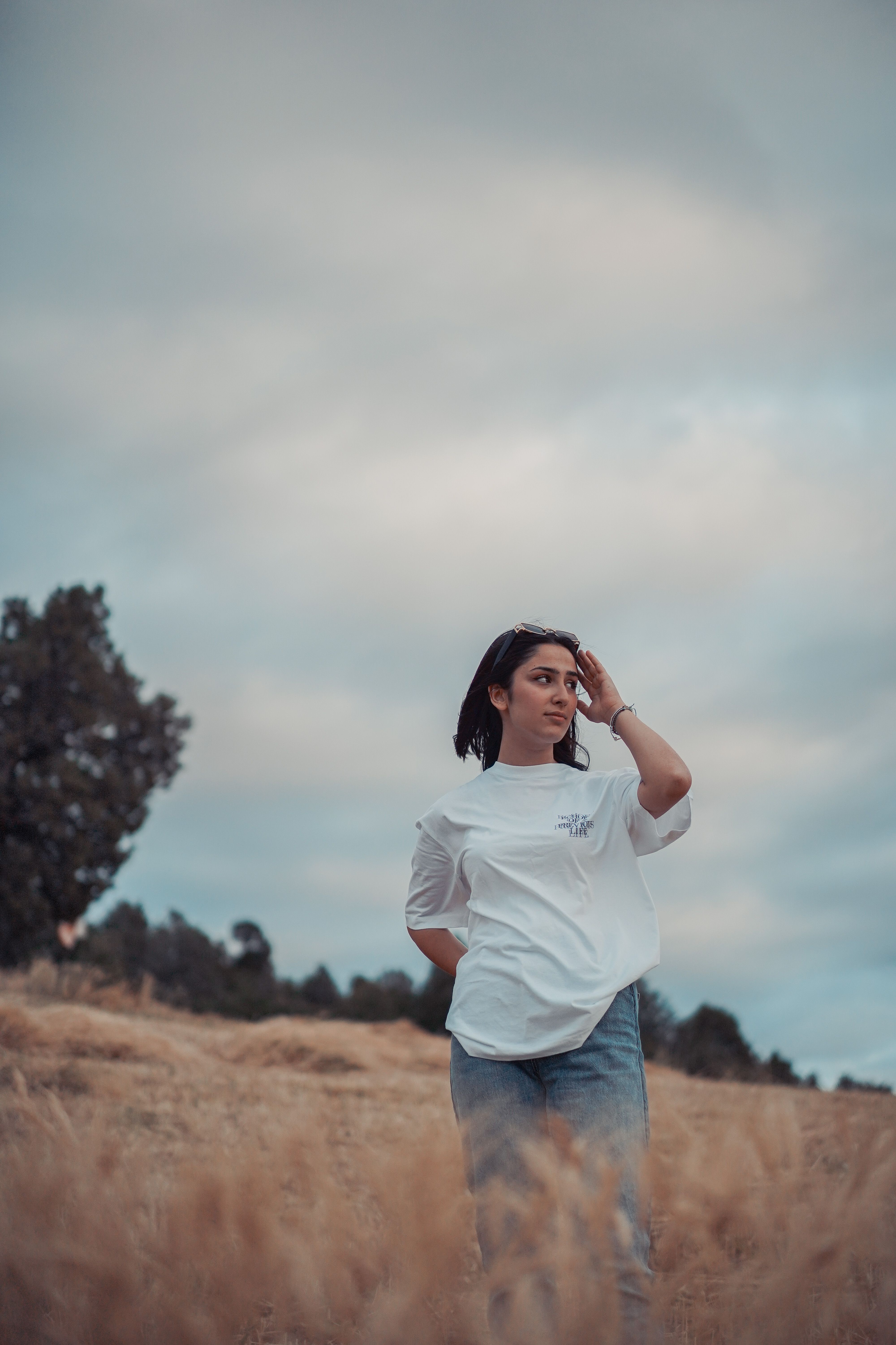 A Woman in White Shirt Standing in the Field · Free Stock Photo
