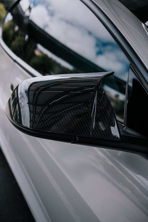 Close-Up Shot of a Carbon Fiber Tesla Side Mirror