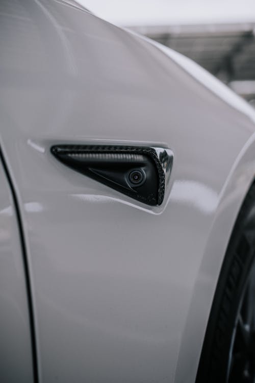 Close-Up Shot of a Tesla Side Camera Carbon Fiber
